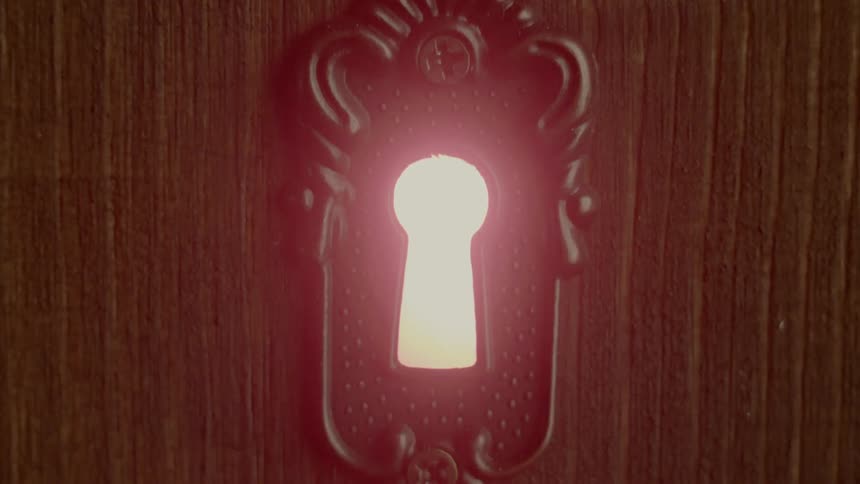 Light shines through a keyhole