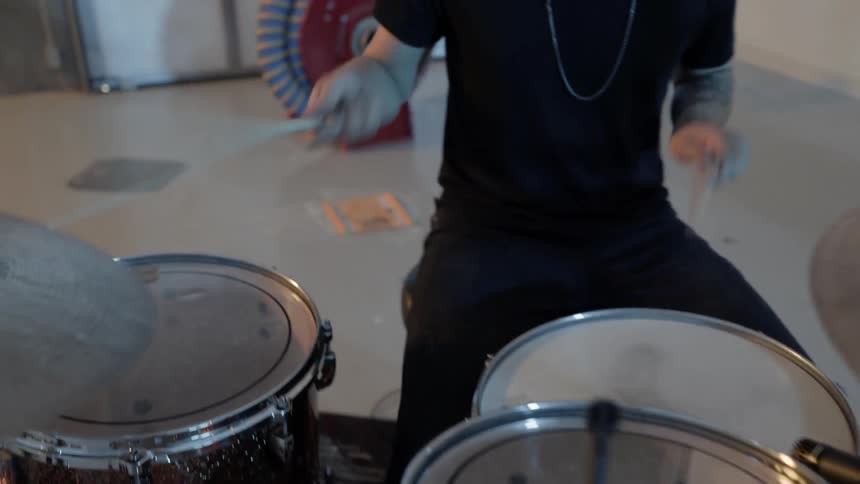 Man playing drums in a garage