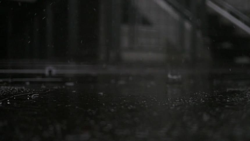 Raindrops falling on concrete
