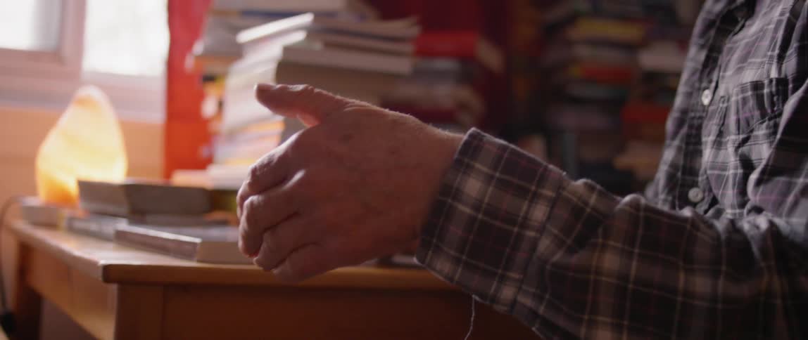A man drinks coffee at a table
