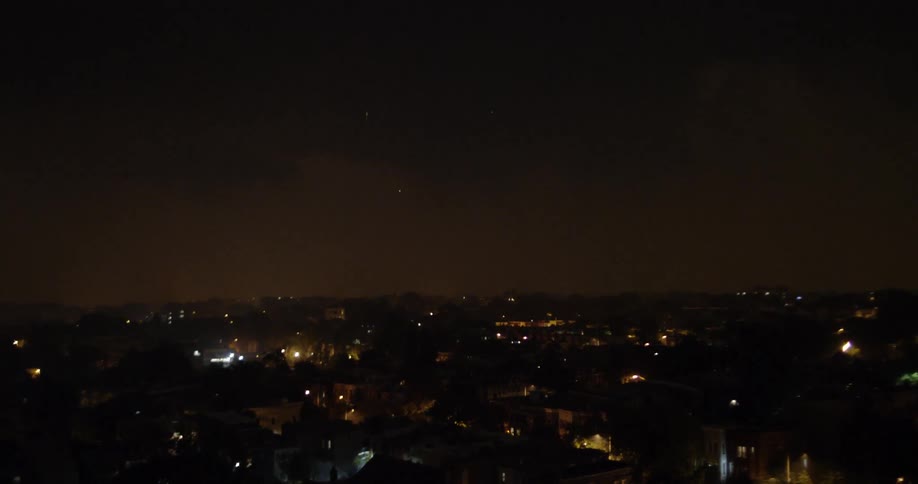 Fireworks explode above city buildings