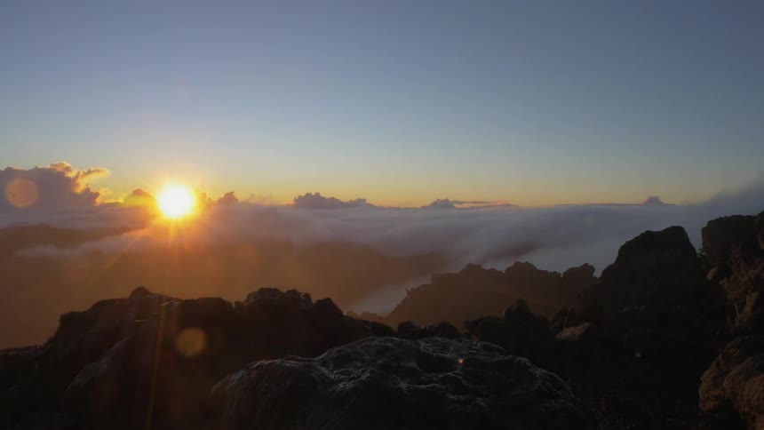Wind and clouds blow over a mountain