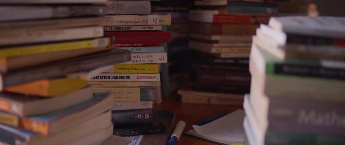 Piles of books on a desk