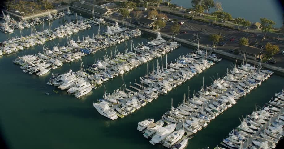 The boats are all neatly docked by the shore