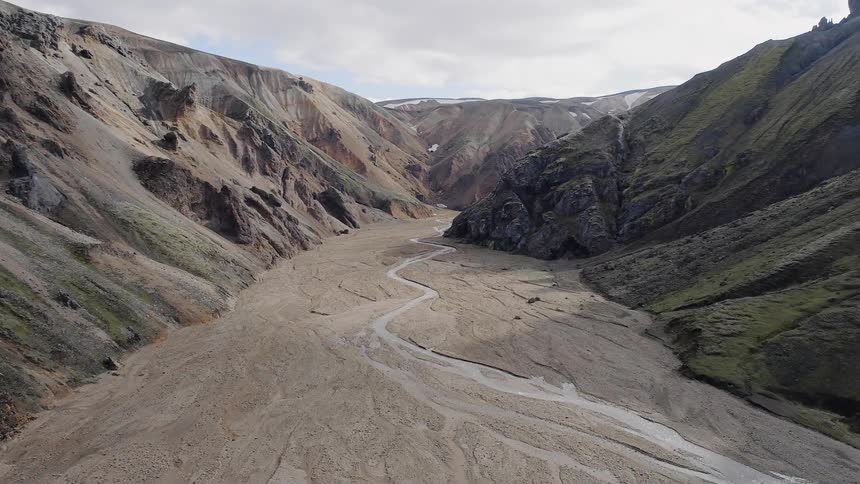 A canyon sits between mountainous formations