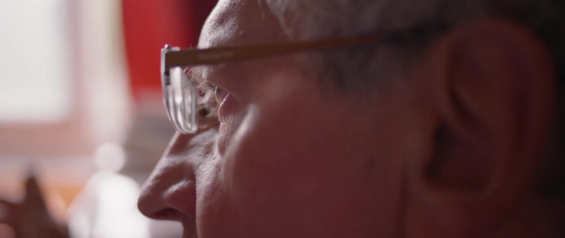 Man wearing glasses blinks as he talks
