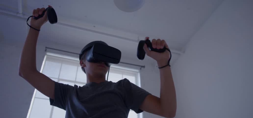 A young man plays with a vr headset