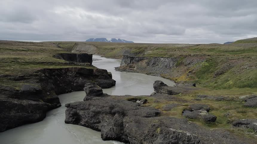 Gray clouds hang above the winding river