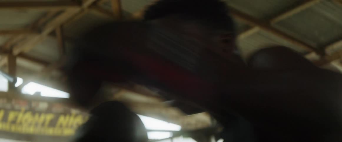 Man shadow boxes in a boxing gym