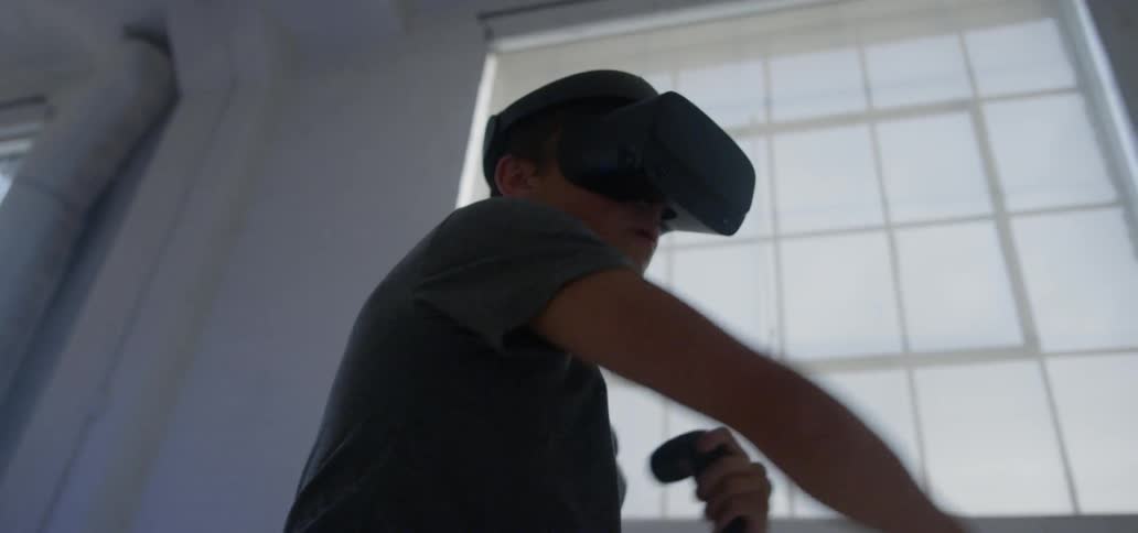 A man is punching wearing a virtual reality headset