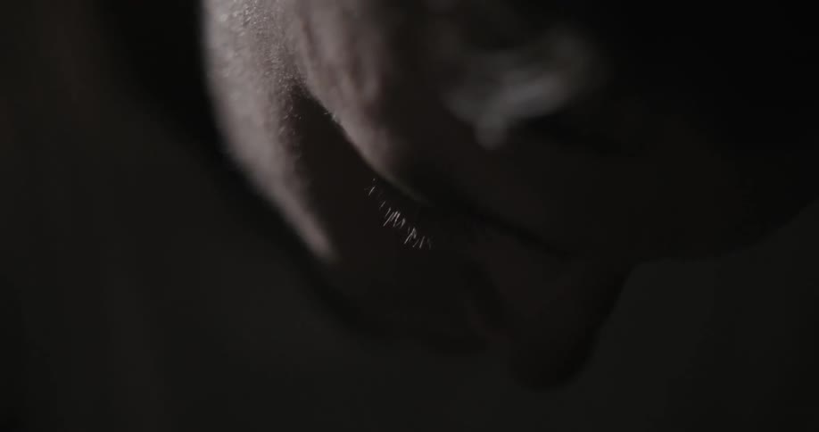 Person looking down in the dark