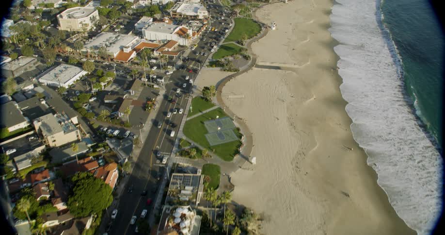 Cars drive on a coastal road
