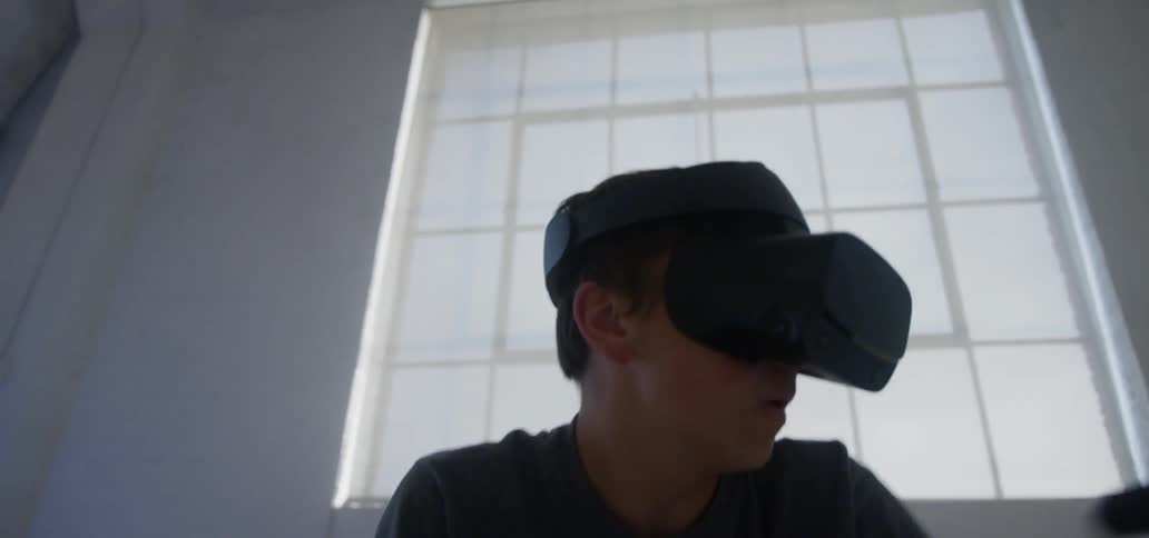A young man plays while wearing a vr headset