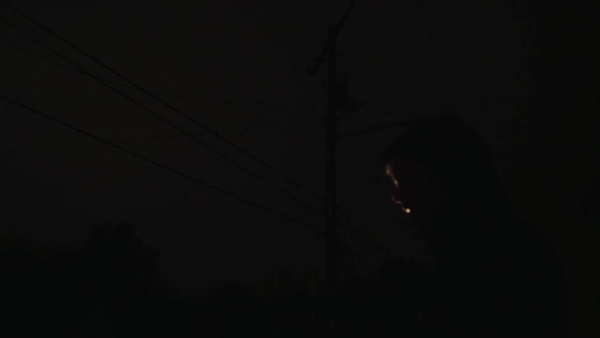 A flashlight shines on the power line