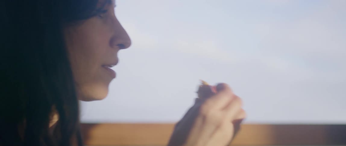 A couple are eating by the window