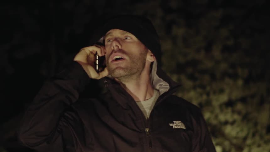 A man searches outside at night