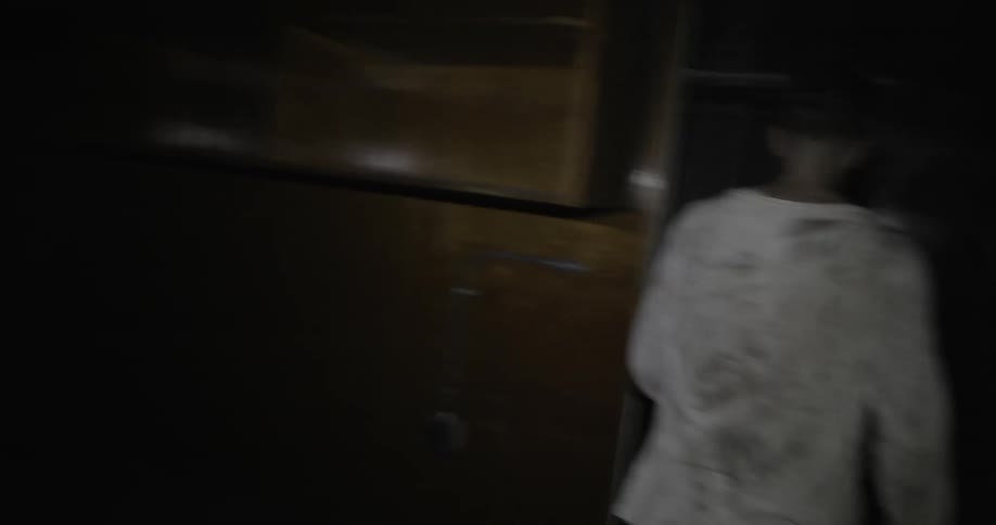 A man walks through a dark building