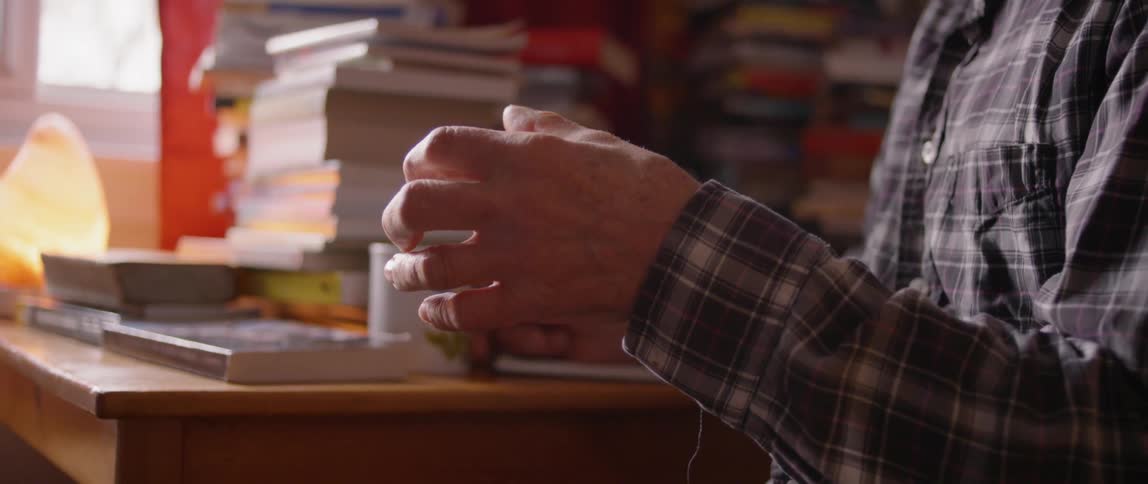 A man talks and moves his hand up and down