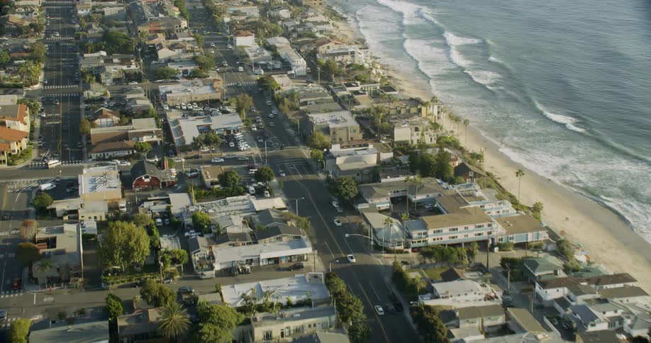 Cars drive in a coastal town
