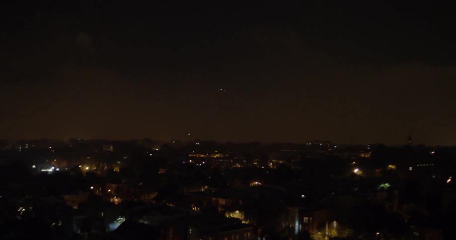 Fireworks shoot into the night sky above the town