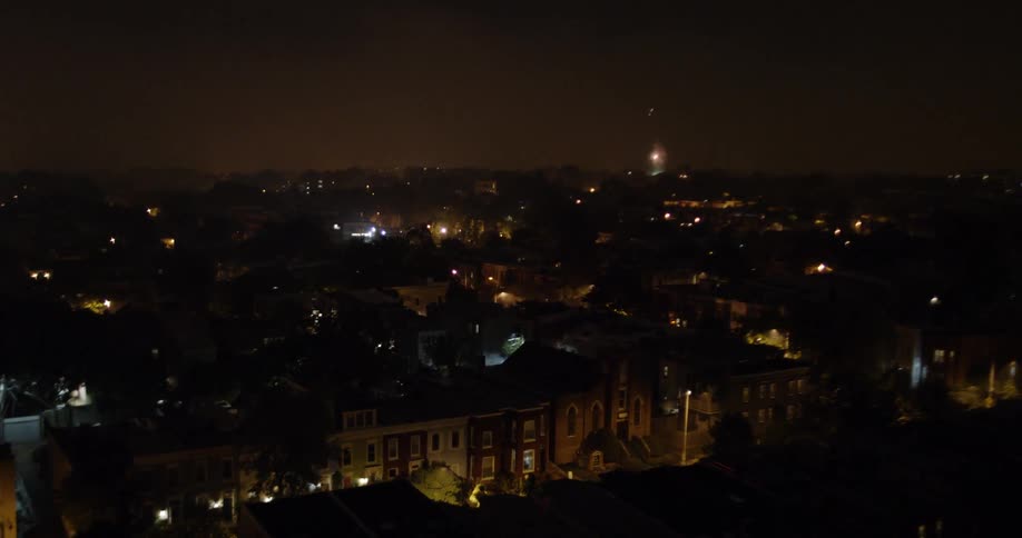 The fireworks explode over the town at night