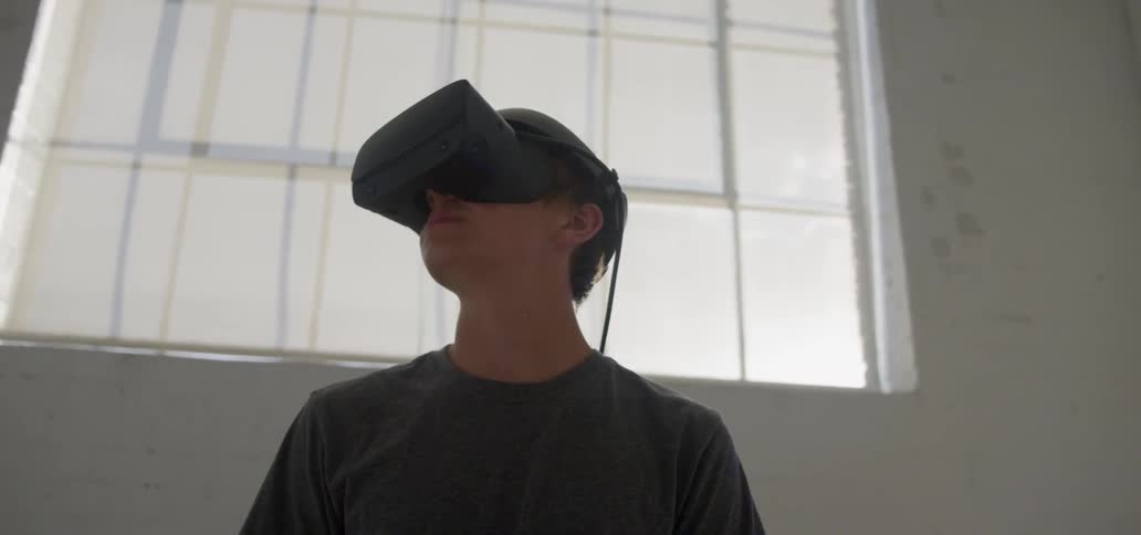 A boy wears a virtual reality headset
