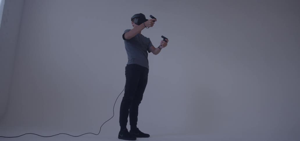 Man wearing virtual reality gear moves his arms around