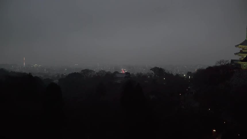 City lights glow dimly in the fog