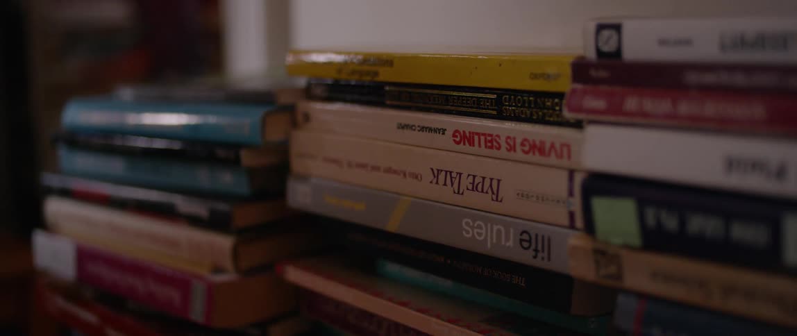 A shadow moves over the stacks of books