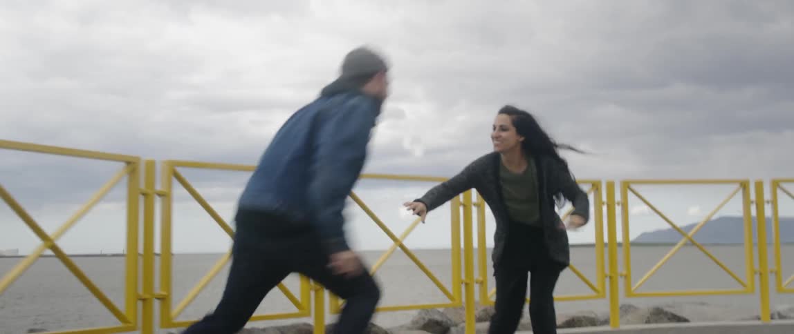 Man and woman run and play holding hands