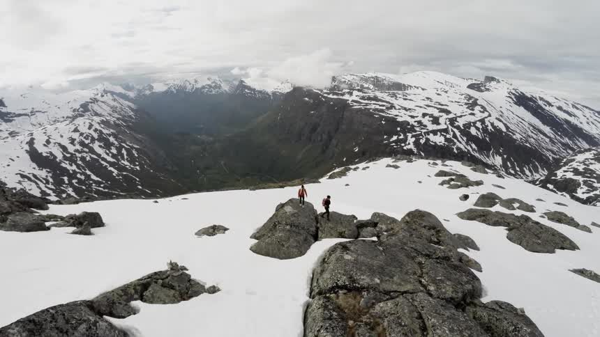 Hikers climb on a snowy mountain top