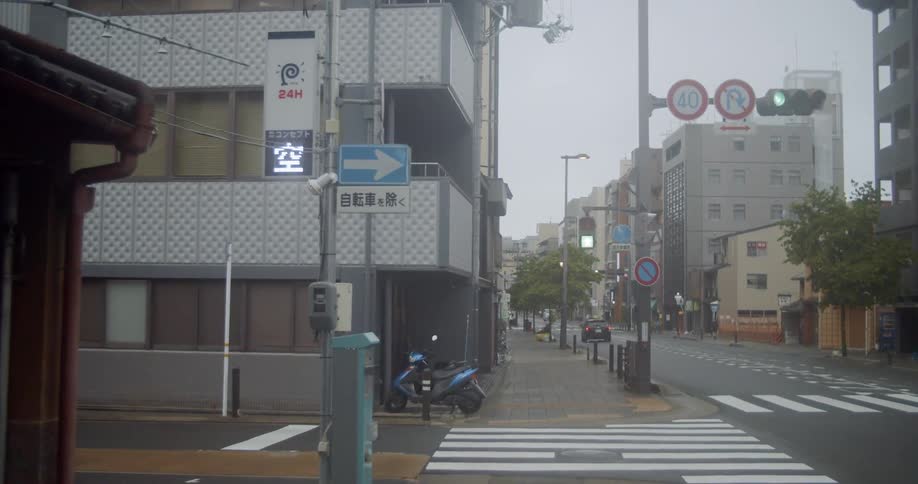A pedestrian walks on a city sidewalk