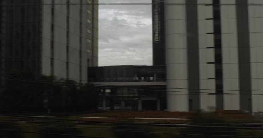 The train passes the buildings by the station