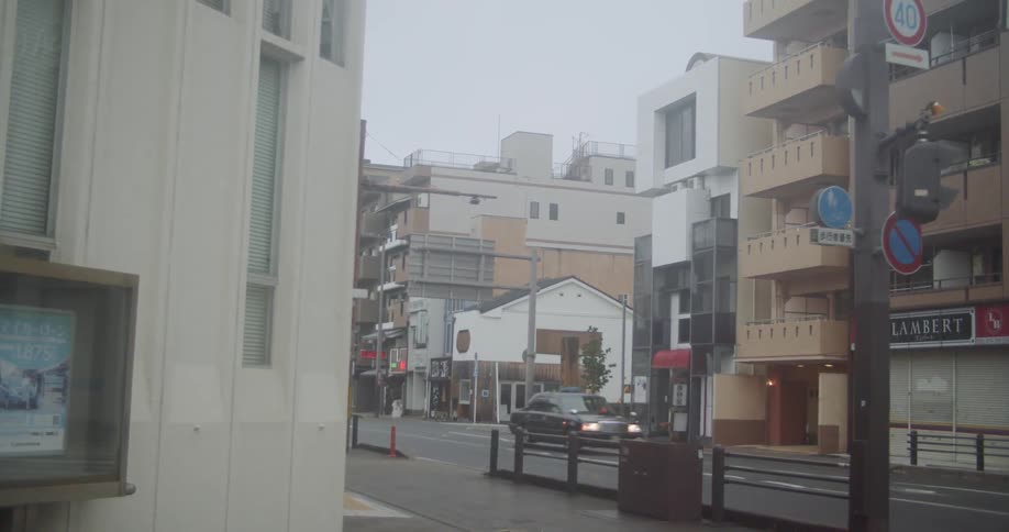 Cars drive on a city street