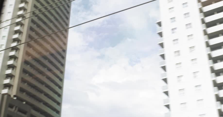 Behind the power lines are tall buildings