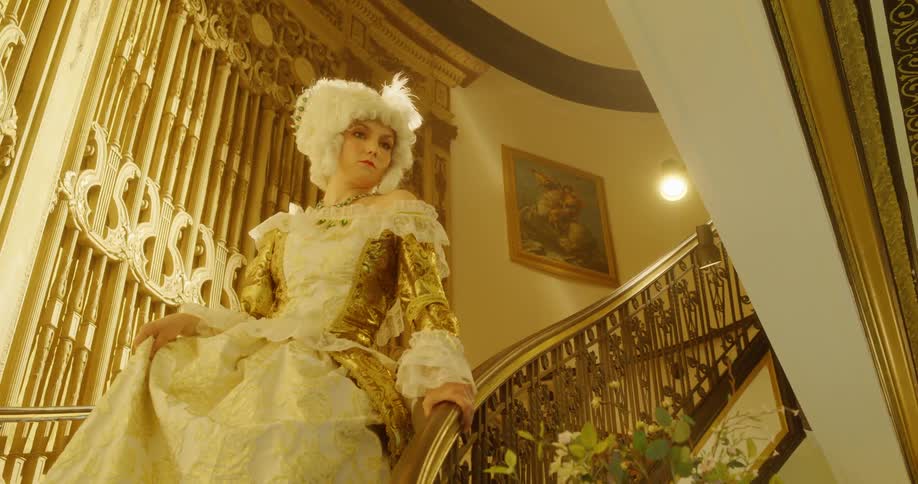 A woman walks slowly down the stairs