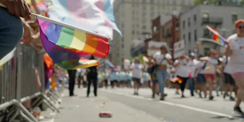 A parade walks by on a sunny day