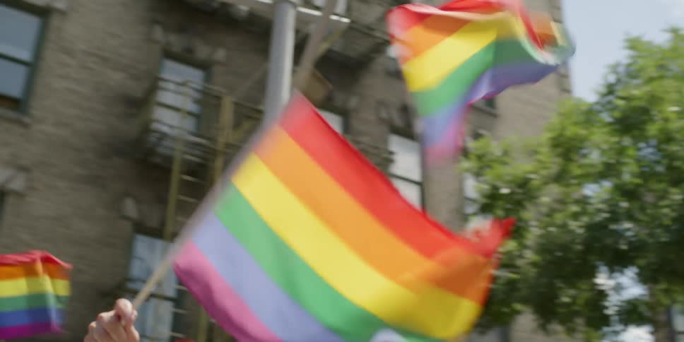 People wave rainbow flags