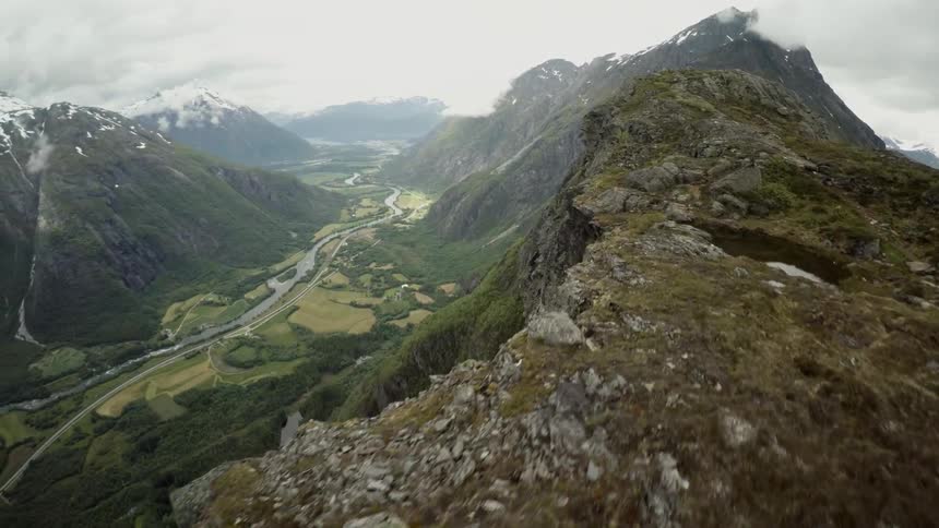 Fly-by showing two people on a mountain