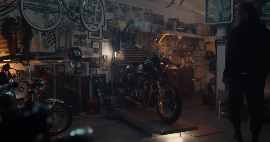 Man Working On Motorcycle In Garage