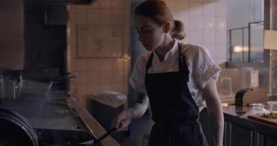 Two chefs work in a restaurant kitchen