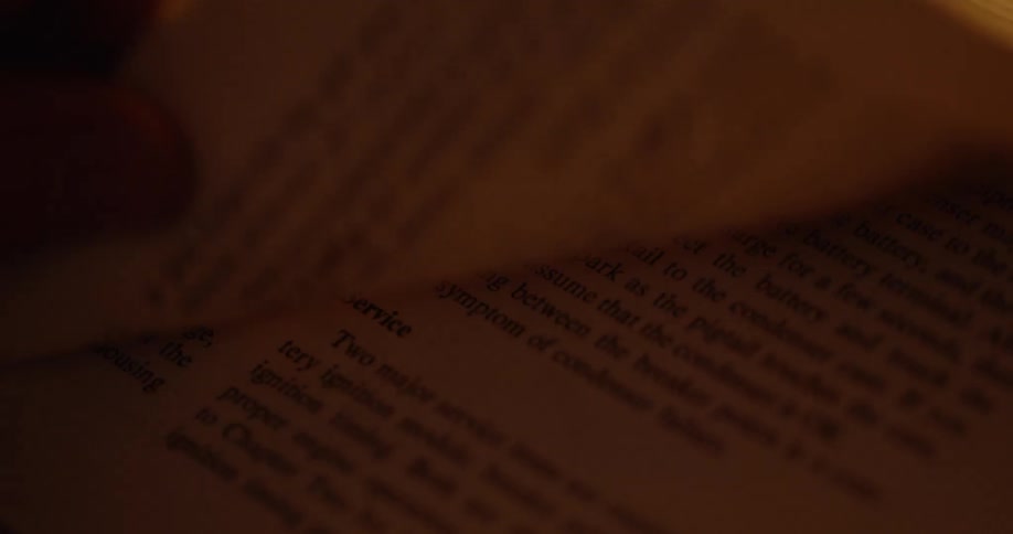 A person turns the page of a book