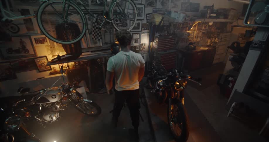 A man walks around his garage