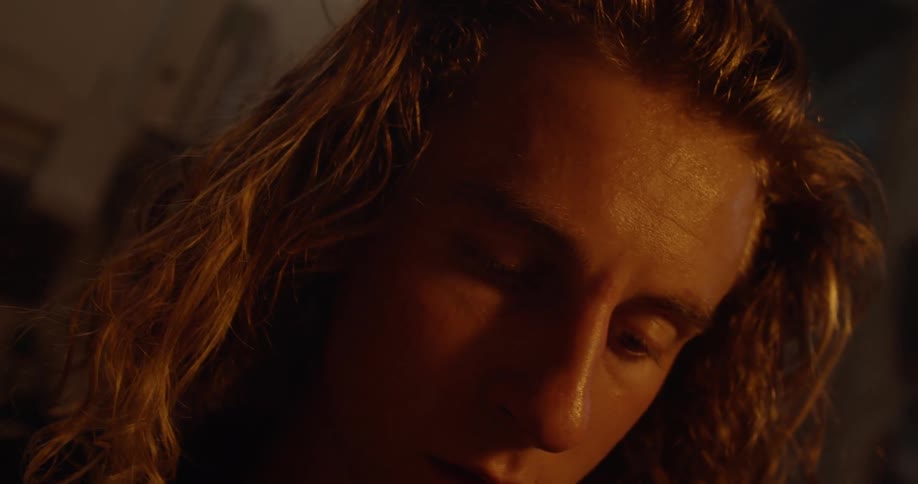 Man's face illuminated by firelight