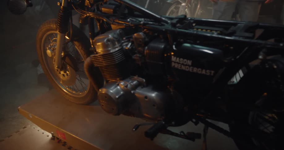 Man Working On Motorcycle In Garage