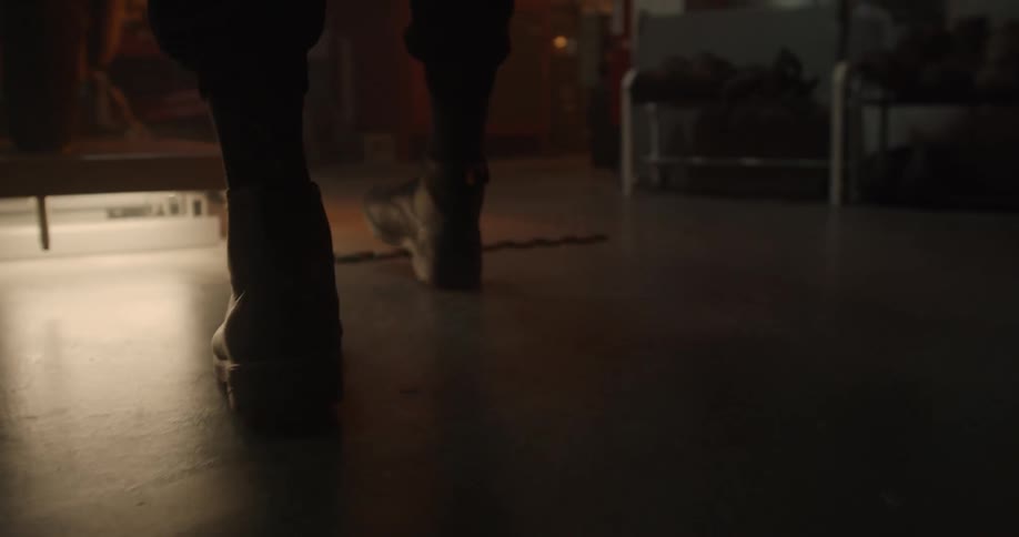 A person walks in a dark room