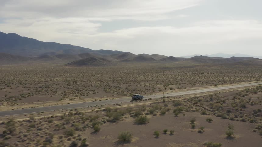 A car travels on a desert road