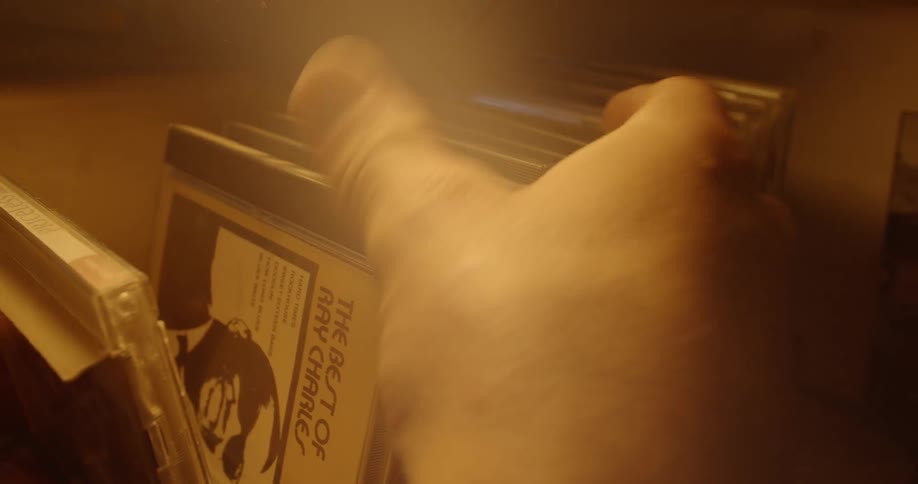 A person flips through a cd collection