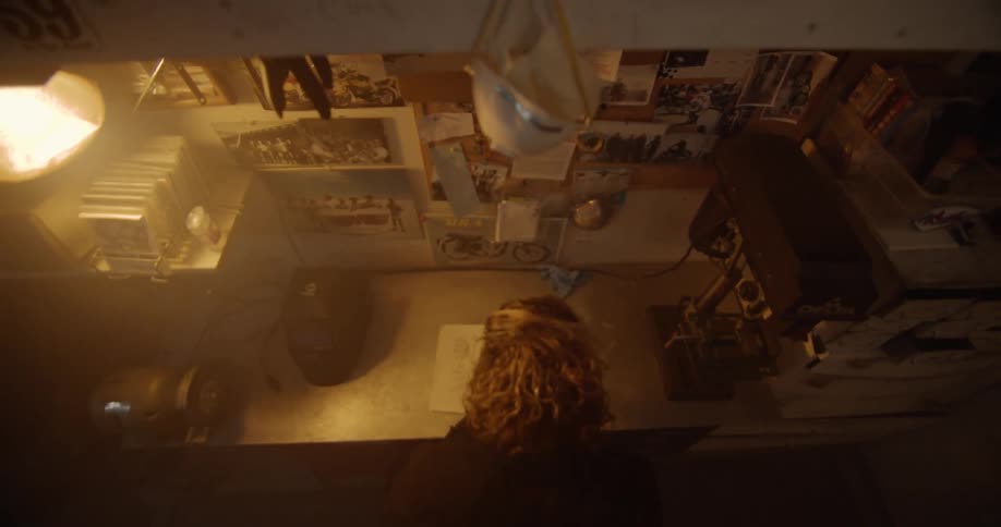 A person sits at a workbench