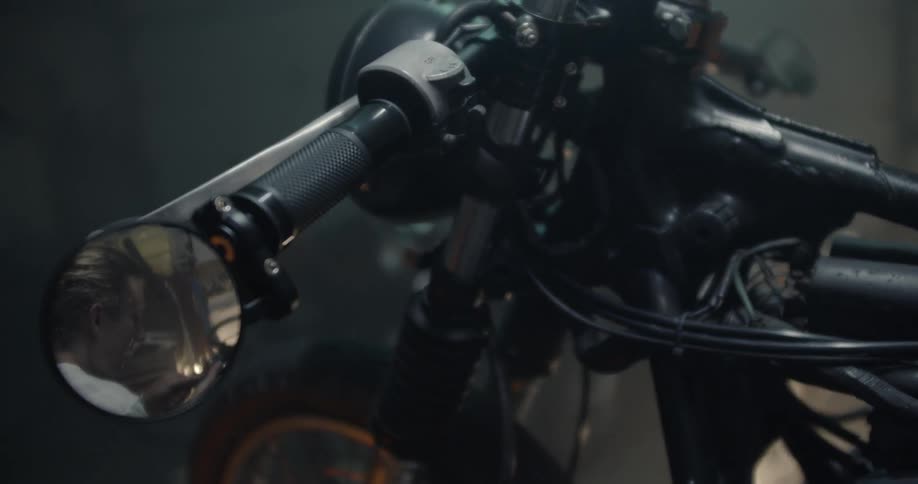 Man Working On Motorcycle In Garage